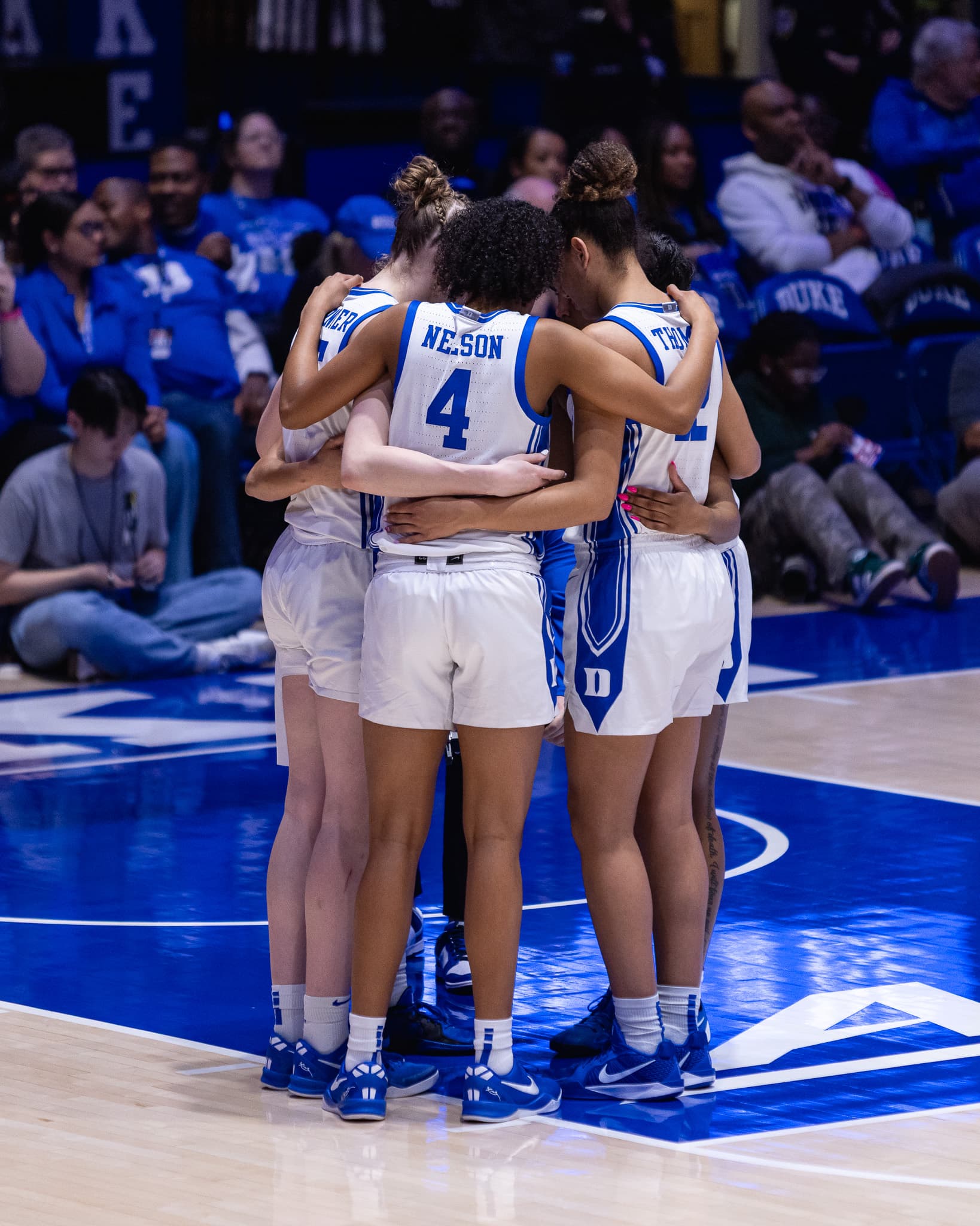 A team huddled together at centre court