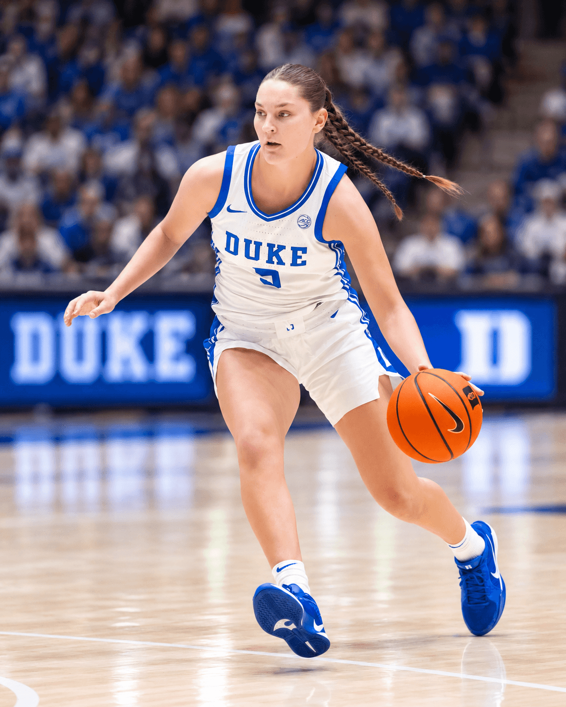 A Duke player driving the ball up court