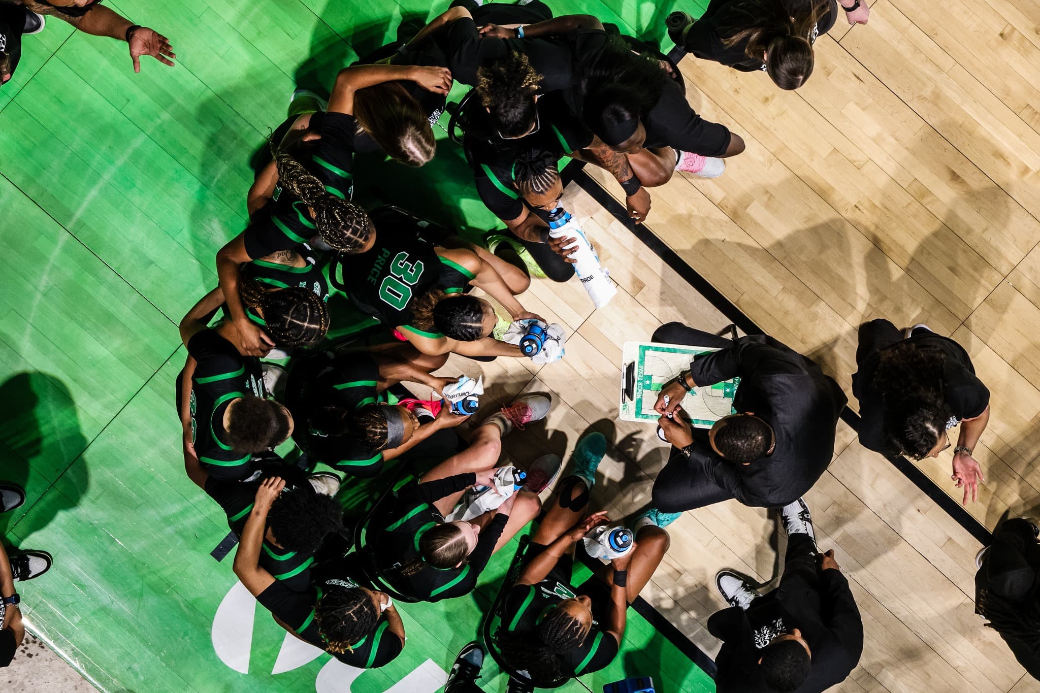 The North Texas team huddled together, seen from above